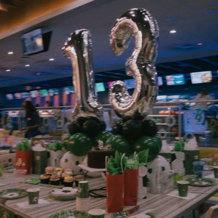 Silver 13 balloons and party decor on a bowling alley party table